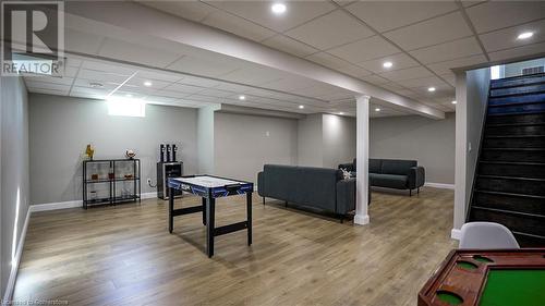 Recreation room featuring a drop ceiling and hardwood / wood-style floors - 219 Falconridge Drive, Waterloo, ON - Indoor Photo Showing Basement