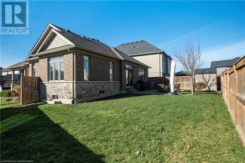 View of side of property with a patio area and a yard - 219 Falconridge Drive, Waterloo, ON - Outdoor