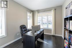 Office area with dark hardwood / wood-style flooring - 