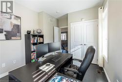 Home office featuring dark wood-type flooring - 