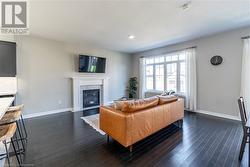 Living room with dark hardwood / wood-style flooring - 