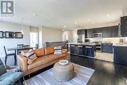 Living room featuring light wood-type flooring and sink - 