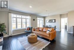 Living room featuring dark wood-type flooring - 