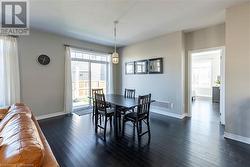 Dining room with dark wood-type flooring - 