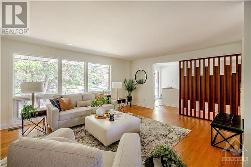 View of Living Room from Corner near Kitchen - Large Living Room, Bright Natural Light, Beautiful Wood Accent Wall - 9 Kingsford Crescent, Kanata, ON - Indoor Photo Showing Living Room