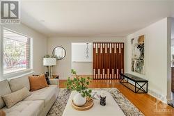 View of Living Room from Fireplace - Open Concept with Beautiful Accent Lights leading down Staircase to Basement - 