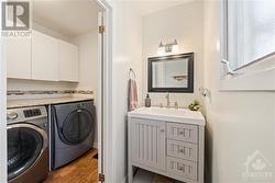 Main floor powder room and washer dryer in mud room right off kitchen. - 