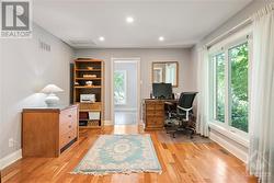 Main floor office with french doors and cherry hardwood flooring. - 