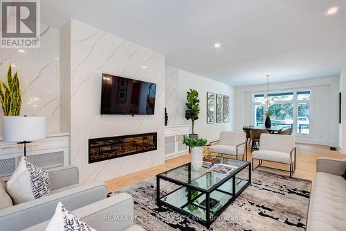 4 Tredvalley Grove, Toronto, ON - Indoor Photo Showing Living Room With Fireplace