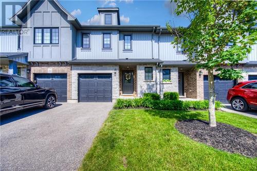 Exterior finish with natural stone and maintenance-free vinyl siding with aluminum soffit, fascia and eavestroughs. Energy efficient low E argon black vinyl windows, premium carriage style garage doo - 625 Blackbridge Road Unit# 12, Cambridge, ON - Outdoor With Facade