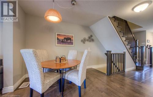 Open concept spacious dining area, oak railing leading to lower and upper level. Upgraded floors and light fixture. - 625 Blackbridge Road Unit# 12, Cambridge, ON - Indoor Photo Showing Dining Room