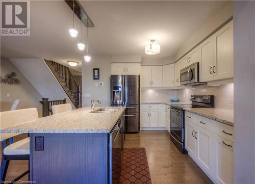 Premium appliances. Granite countertops with undermount sink. Custom cabinetry with soft close doors and drawers. - 625 Blackbridge Road Unit# 12, Cambridge, ON - Indoor Photo Showing Kitchen With Upgraded Kitchen