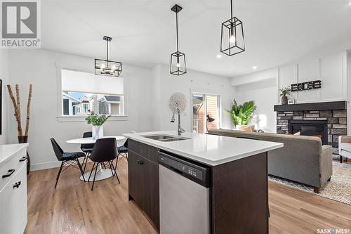 72 900 St Andrews Lane, Warman, SK - Indoor Photo Showing Kitchen With Fireplace With Double Sink