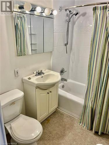 Full bathroom with shower / bath combo with shower curtain, vanity, and toilet - 810 Main Street W Unit# 302, North Bay, ON - Indoor Photo Showing Bathroom