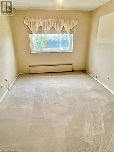 Carpeted empty room with a baseboard radiator - 810 Main Street W Unit# 302, North Bay, ON - Indoor Photo Showing Other Room