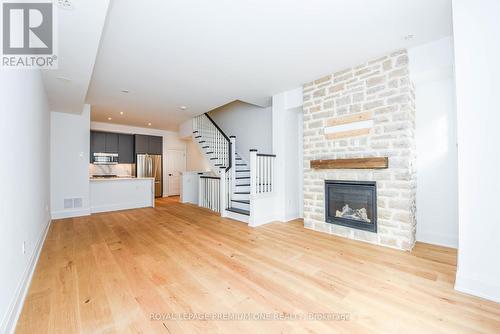 125 - 35 Lunar Crescent, Mississauga, ON - Indoor Photo Showing Living Room With Fireplace