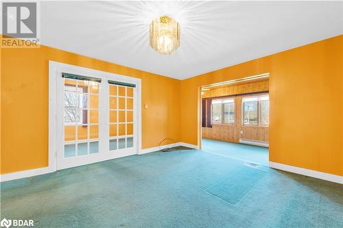 Empty room with carpet, plenty of natural light, and a baseboard heating unit - 14686 County Road 509, Mississippi Station, ON - Indoor Photo Showing Other Room