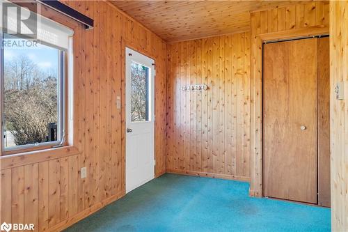 Unfurnished room with carpet flooring, wooden ceiling, and wooden walls - 14686 County Road 509, Mississippi Station, ON - Indoor Photo Showing Other Room