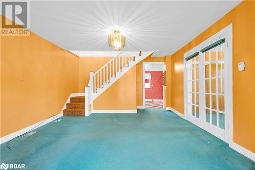 Unfurnished living room with carpet flooring and a chandelier - 14686 County Road 509, Mississippi Station, ON - Indoor Photo Showing Other Room