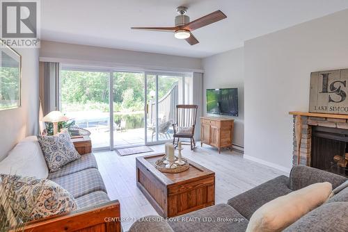 Unit 16 - 2 Paradise Boulevard, Ramara, ON - Indoor Photo Showing Living Room With Fireplace