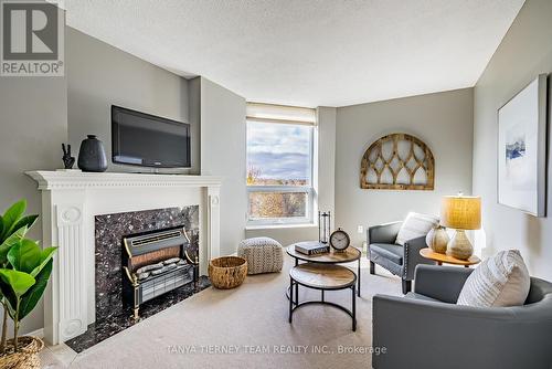 405 - 700 Wilson Road N, Oshawa, ON - Indoor Photo Showing Living Room With Fireplace