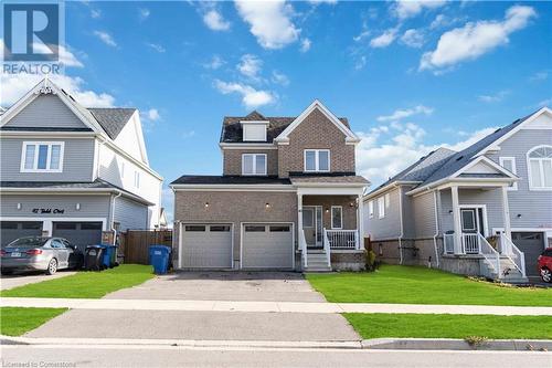 View of front of house with a porch, a garage, and a front lawn - 40 Todd Crescent, Dundalk, ON - Outdoor With Facade