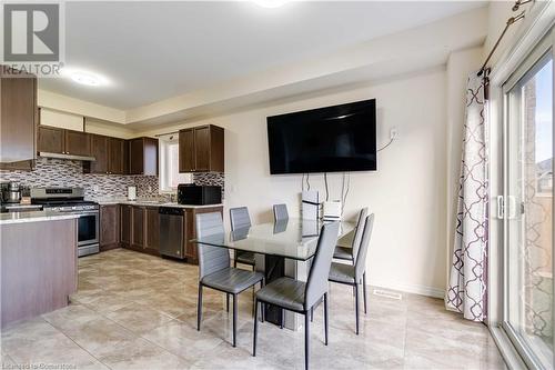 Kitchen featuring backsplash, dark brown cabinets, stainless steel appliances, ventilation hood, and sink - 40 Todd Crescent, Dundalk, ON - Indoor