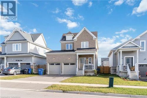 View of front facade with a porch, a front yard, and a garage - 40 Todd Crescent, Dundalk, ON - Outdoor With Facade