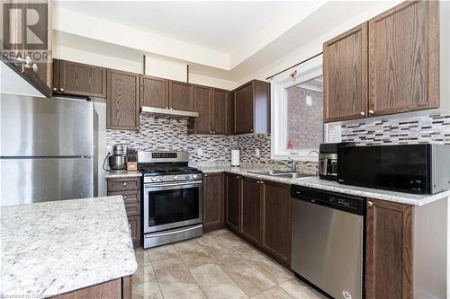 Kitchen with sink, decorative backsplash, range hood, appliances with stainless steel finishes, and dark brown cabinets - 40 Todd Crescent, Dundalk, ON - Indoor Photo Showing Kitchen With Stainless Steel Kitchen With Double Sink With Upgraded Kitchen