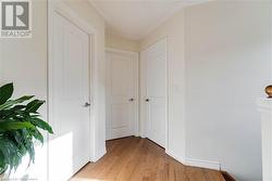 Hallway with light hardwood / wood-style flooring - 