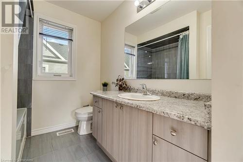 Full bathroom featuring tile patterned floors, vanity, toilet, and shower / bathtub combination with curtain - 40 Todd Crescent, Dundalk, ON - Indoor Photo Showing Bathroom