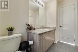 Bathroom with tile patterned flooring, vanity, and toilet - 