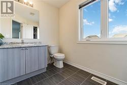 Bathroom with vanity and toilet - 