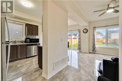 Kitchen with stainless steel dishwasher, plenty of natural light, dark brown cabinetry, and sink - 40 Todd Crescent, Dundalk, ON - Indoor