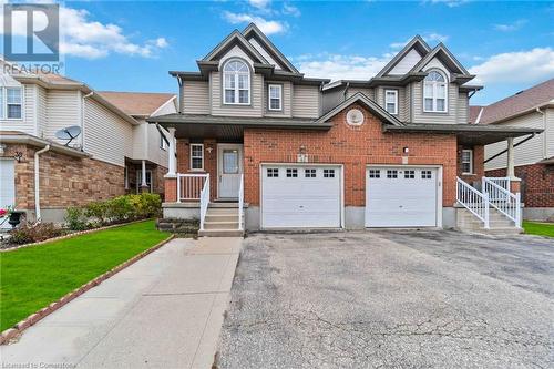 View of front facade with a garage, a porch, and a front yard - 42 Donnenwerth Drive, Kitchener, ON - Outdoor With Facade