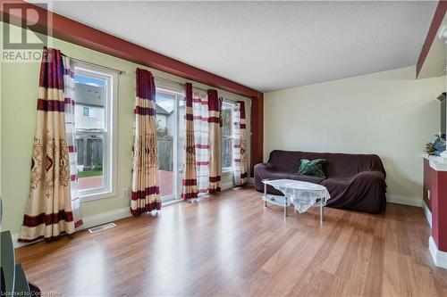 Living room featuring plenty of natural light, light hardwood / wood-style flooring, and a textured ceiling - 42 Donnenwerth Drive, Kitchener, ON - Indoor