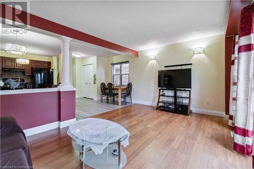 Living room with light wood-type flooring and ornate columns - 42 Donnenwerth Drive, Kitchener, ON - Indoor Photo Showing Other Room