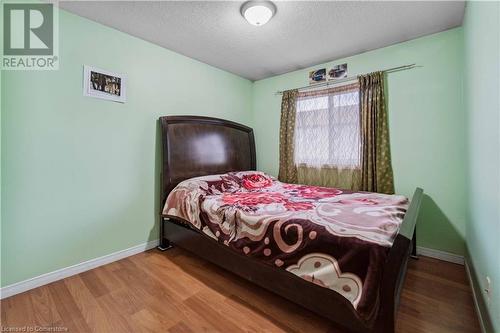 Bedroom featuring wood-type flooring and a textured ceiling - 42 Donnenwerth Drive, Kitchener, ON - Indoor Photo Showing Bedroom