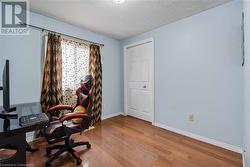 Home office with hardwood / wood-style floors and a textured ceiling - 