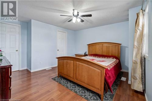 Bedroom with dark wood-type flooring, ceiling fan, and a textured ceiling - 42 Donnenwerth Drive, Kitchener, ON - Indoor Photo Showing Bedroom