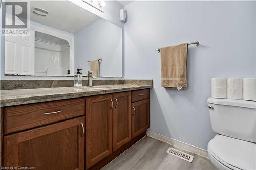 Bathroom featuring toilet, vanity, and wood-type flooring - 42 Donnenwerth Drive, Kitchener, ON - Indoor Photo Showing Bathroom