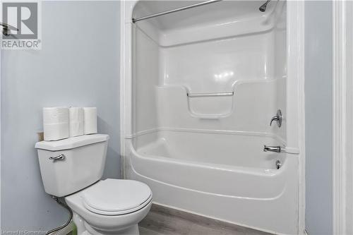 Bathroom with hardwood / wood-style floors and toilet - 42 Donnenwerth Drive, Kitchener, ON - Indoor Photo Showing Bathroom