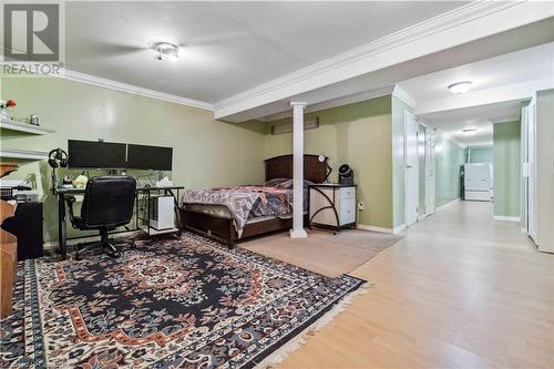 Bedroom with hardwood / wood-style flooring, crown molding, and white refrigerator - 42 Donnenwerth Drive, Kitchener, ON - Indoor