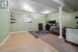 Bedroom with ornamental molding and wood-type flooring - 