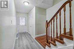 Entryway with light hardwood / wood-style floors and a textured ceiling - 