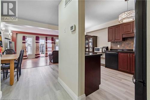 Kitchen with fridge, pendant lighting, decorative backsplash, light hardwood / wood-style floors, and dishwasher - 42 Donnenwerth Drive, Kitchener, ON - Indoor