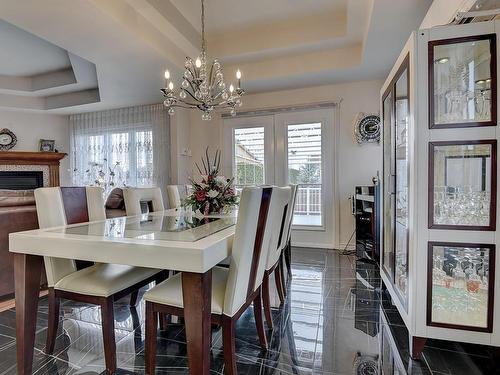 Dining room - 265 Rue Grillon, Saint-Paul, QC - Indoor Photo Showing Dining Room With Fireplace