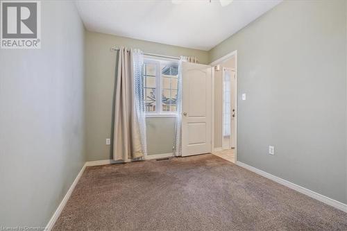 View of carpeted spare room - 24 Kenyon Crescent Unit# 45, Grimsby, ON - Indoor Photo Showing Other Room