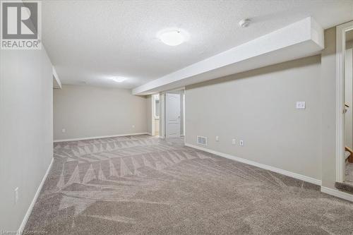 Basement with carpet and a textured ceiling - 24 Kenyon Crescent Unit# 45, Grimsby, ON - Indoor Photo Showing Other Room