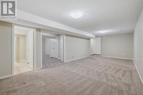 Basement with light colored carpet and a textured ceiling - 24 Kenyon Crescent Unit# 45, Grimsby, ON - Indoor